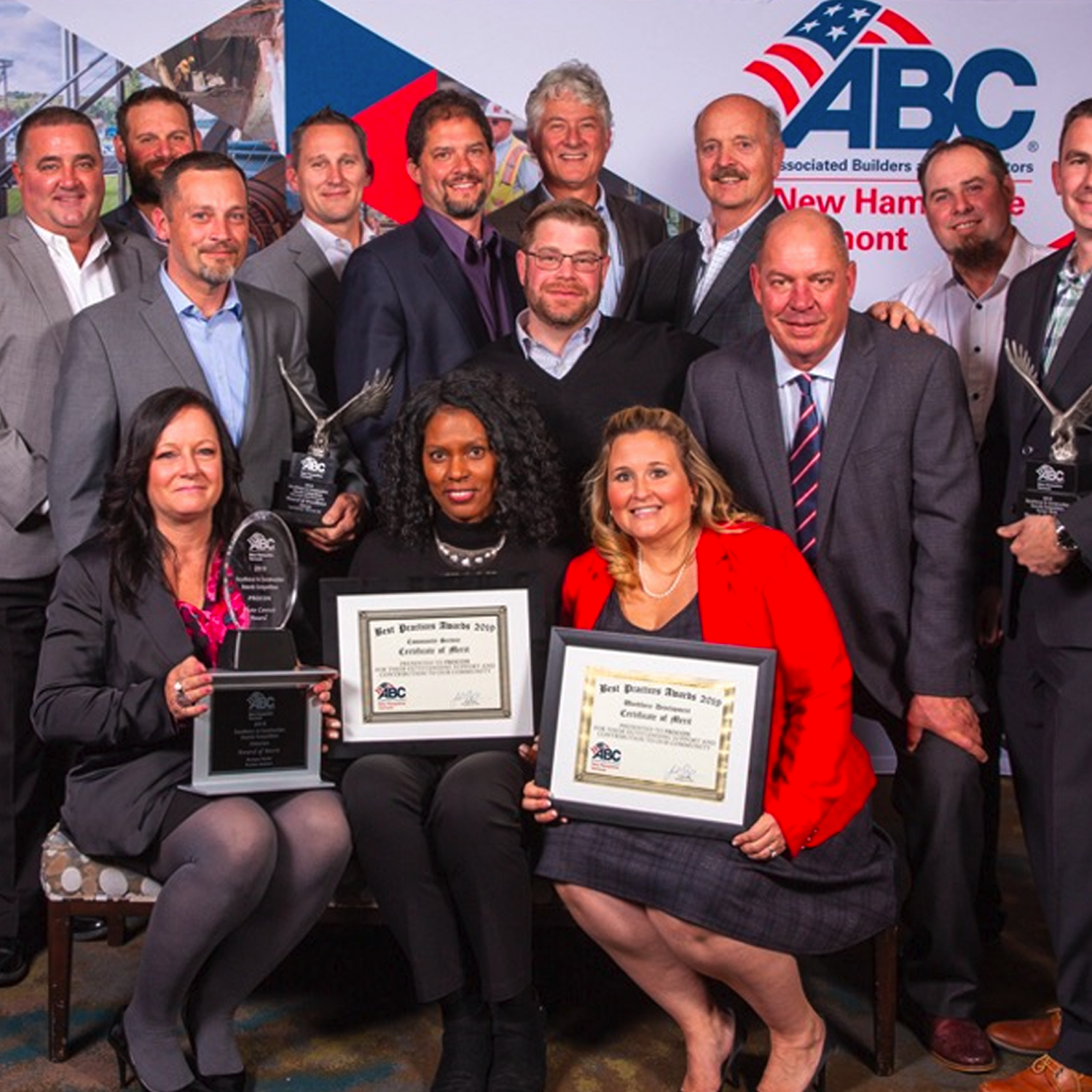 ABC staff holding up their awards.