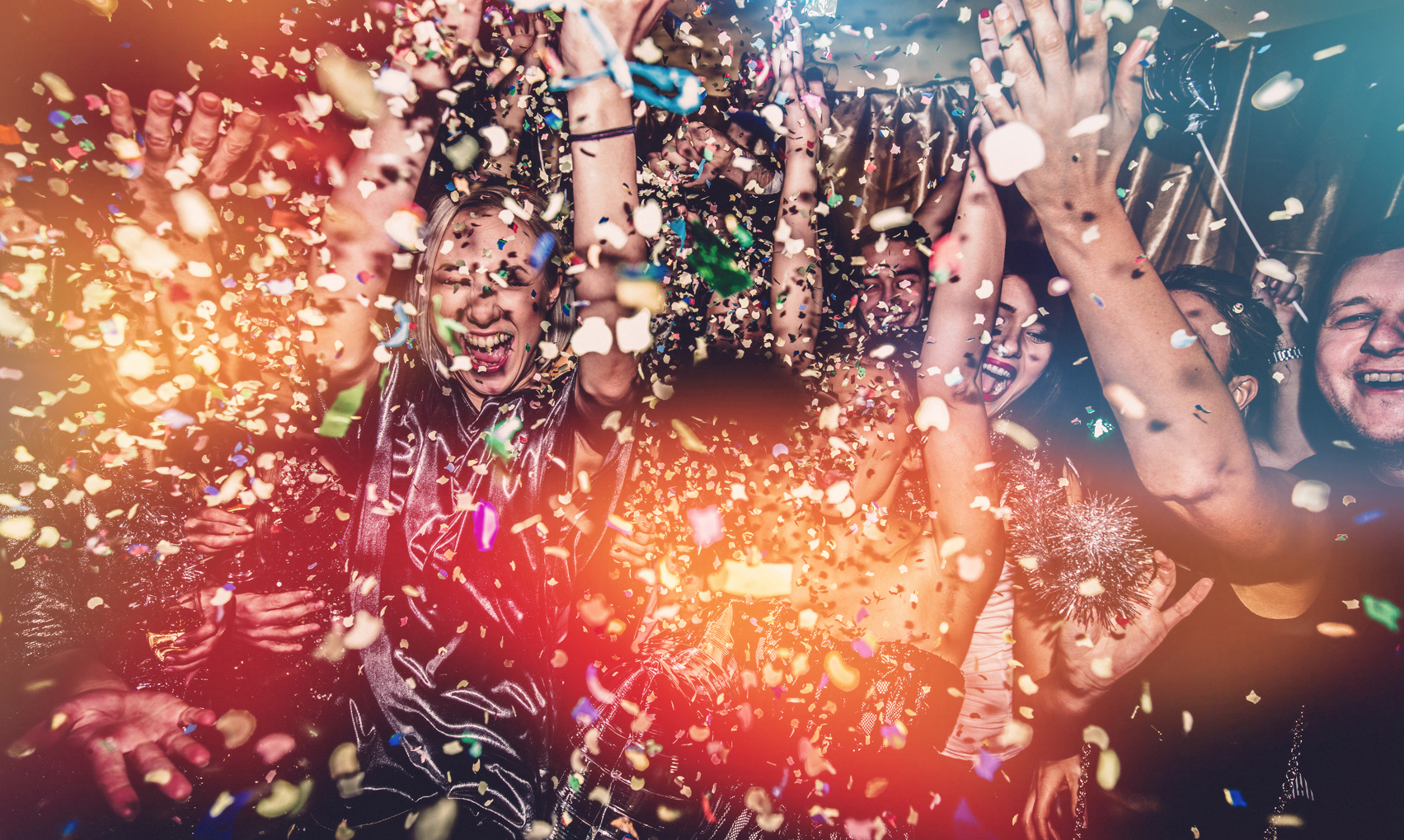 People celebrating at Granite River Studios in New Hampshire with confetti falling down.