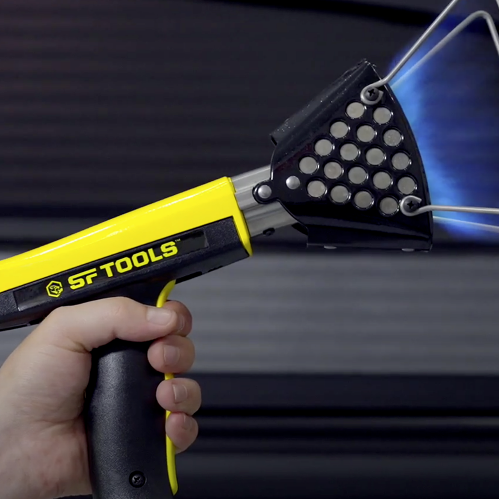 SF Tools heat shrinking tool being held by a hand, as part of a brand video production.